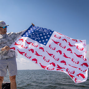Man holding red, white, and blue Sportsman USA Flag. 
