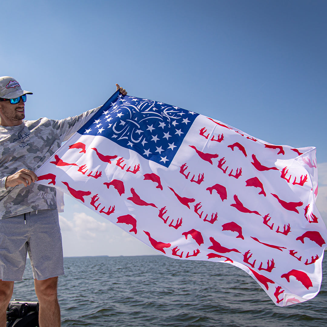 Man holding red, white, and blue American Sportsman Flag.
